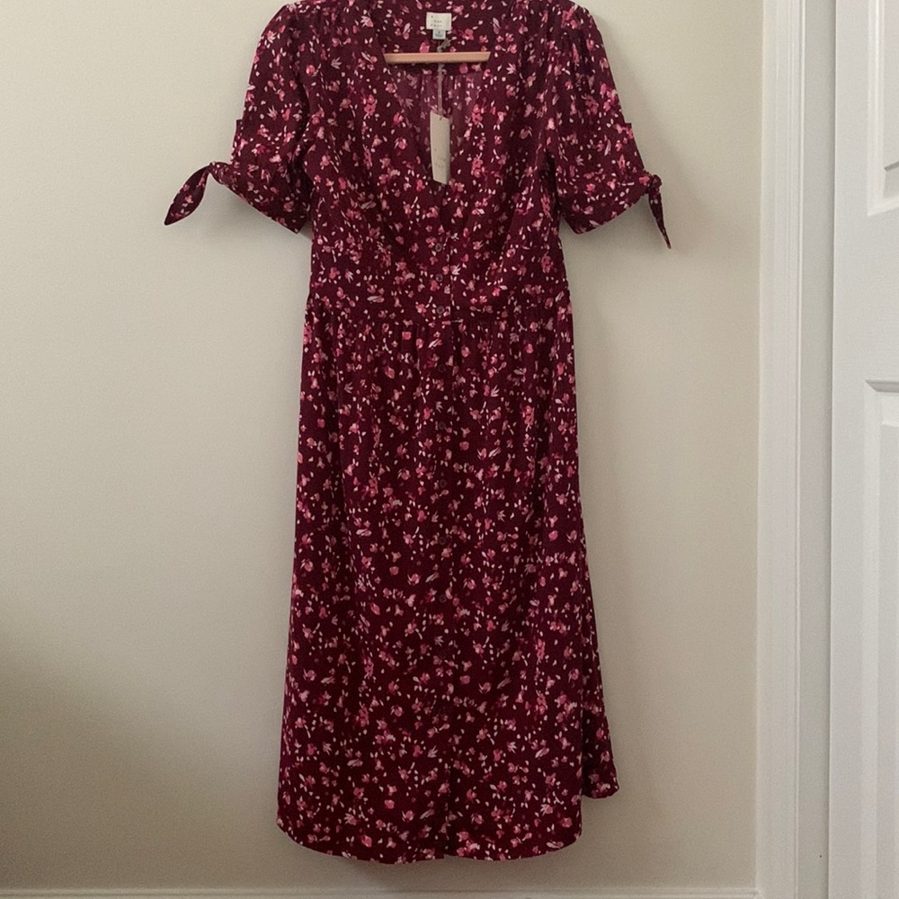 Pretty burgundy dress with flowers for work or play.